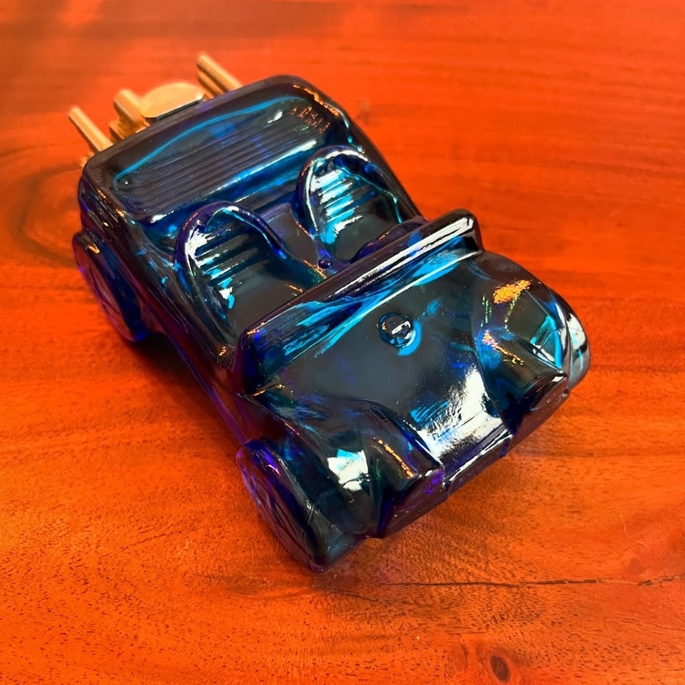 Vintage Avon men’s cologne bottle. Shaped like a car. The cap is an engine.